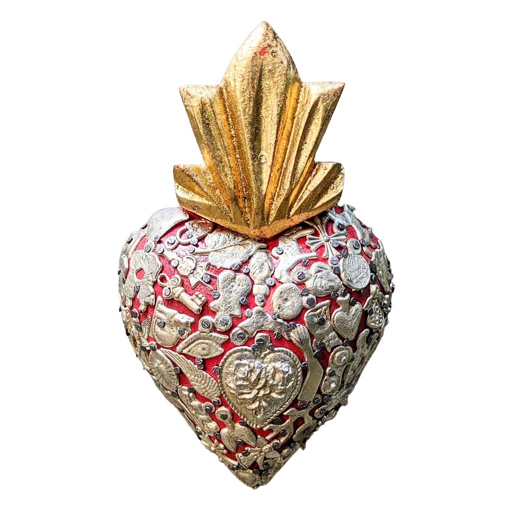 Carved wood heart sculpture covered with small tin milagro charms